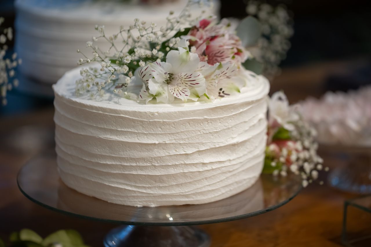 Elegant white cake decorated with soft flowers