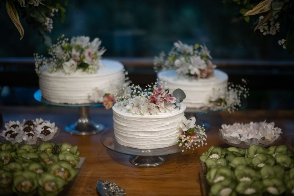 Delicate white cakes with floral decorations, perfect for weddings or special occasions.